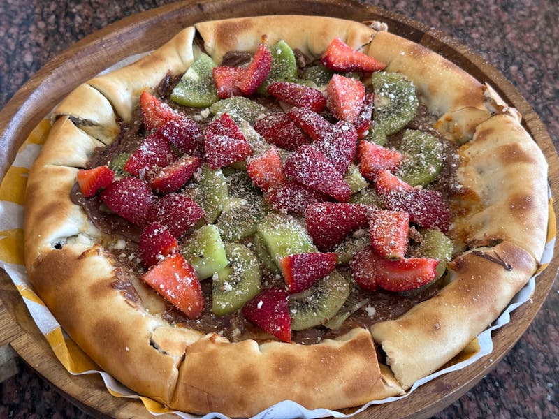 Nutella dessert pizza with fresh strawberries and powdered sugar